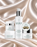 Four ALIGN skincare products arranged on draped champagne satin fabric: a Dream Eye Cream jar, a Dream Cleansing Cream pump bottle, a Dream Eye Cream jar, and a Dream Anti-Aging Cream jar, plus a circular badge noting a complimentary satin sleep mask.