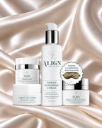 Four ALIGN skincare products arranged on draped champagne satin fabric: a Dream Eye Cream jar, a Dream Cleansing Cream pump bottle, a Dream Eye Cream jar, and a Dream Anti-Aging Cream jar, plus a circular badge noting a complimentary satin sleep mask.