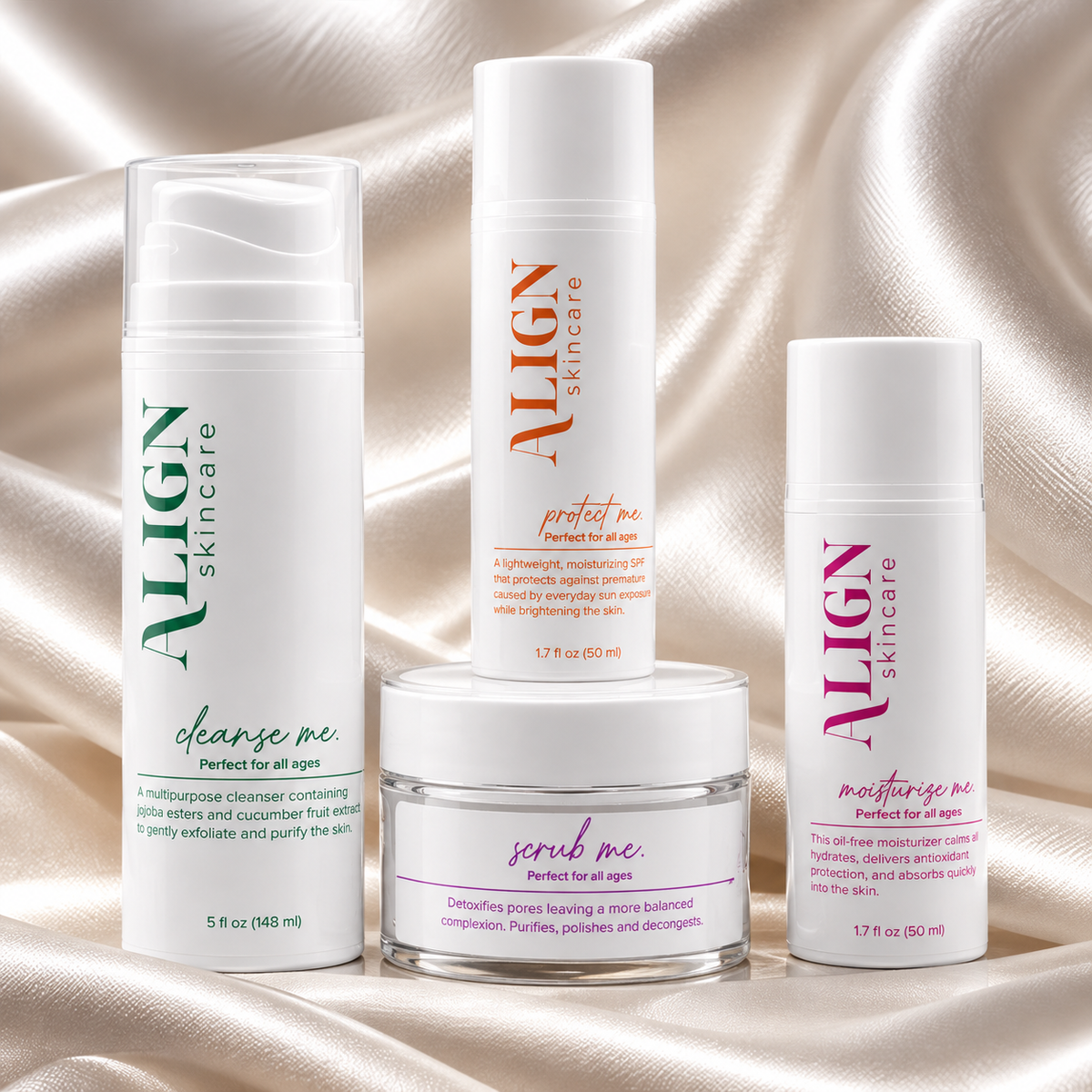 Four ALIGN skincare products arranged on a draped champagne satin background: a clear bottle labeled 'clearse me,' a tall white tube labeled 'perfect me,' a small jar labeled 'scrub me,' and a white bottle labeled 'moisture me.'.